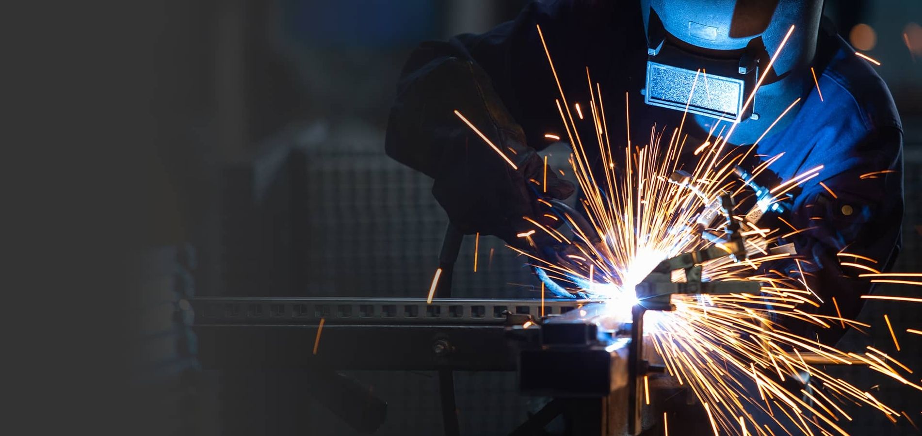 A man working with a welding machine.