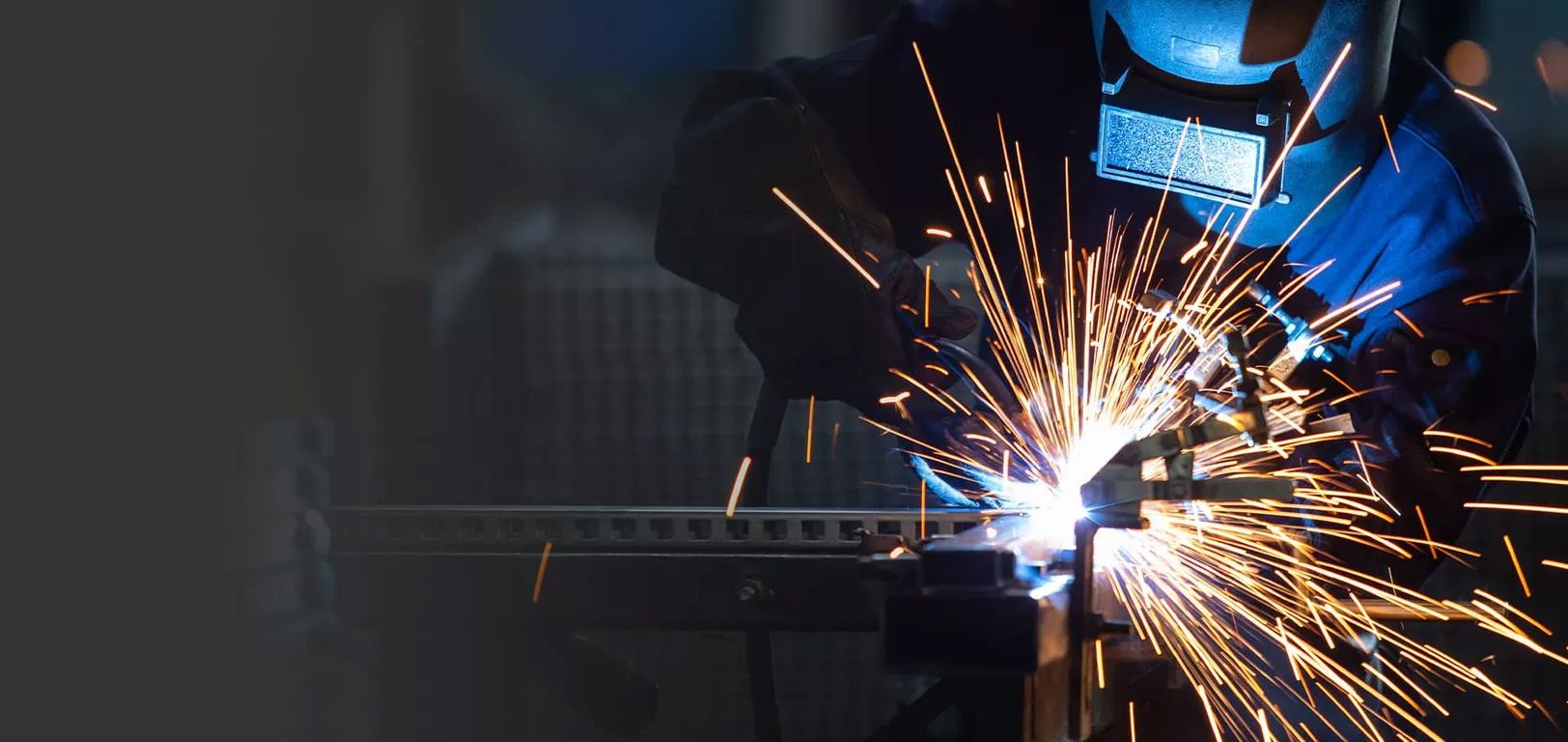 A man working with a welding machine.